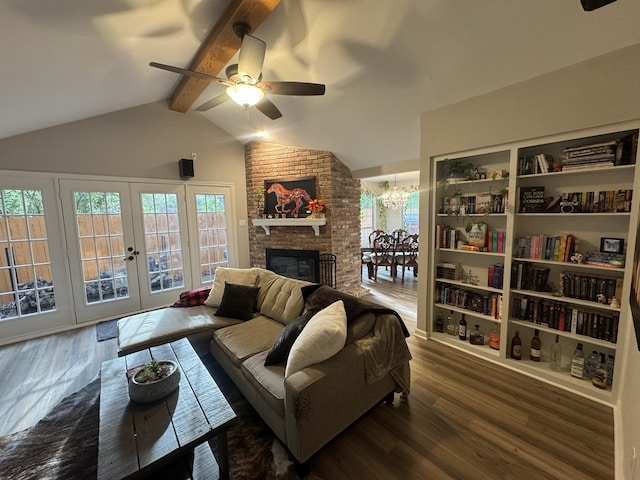 living room featuring a brick fireplace, ceiling fan with notable chandelier, lofted ceiling with beams, and dark hardwood / wood-style flooring