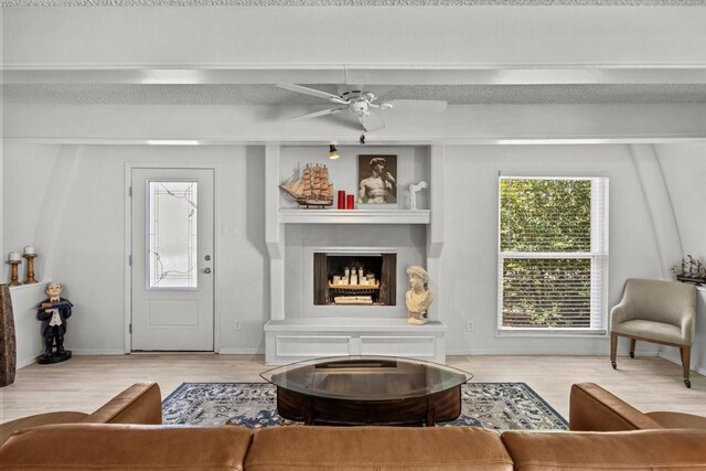 315 Highlander Hts, Hideaway, TX 75771 - living area featuring ceiling fan, baseboards, wood finished floors, and a fireplace with raised hearth