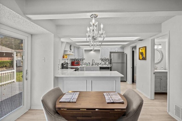 315 Highlander Hts, Hideaway, TX 75771 - dining room with light wood-type flooring, baseboards, and a chandelier