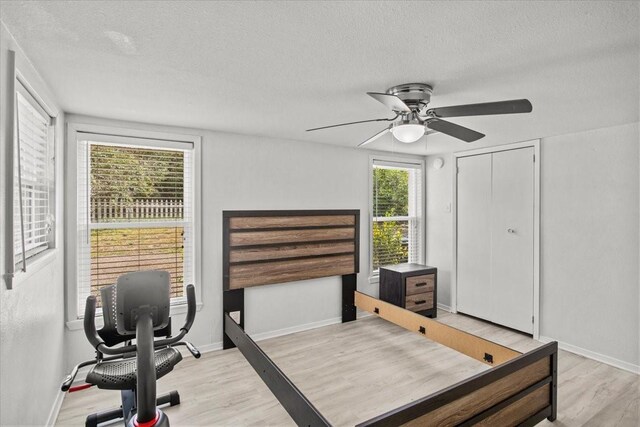 315 Highlander Hts, Hideaway, TX 75771 - bedroom featuring a textured ceiling, light wood finished floors, and baseboards