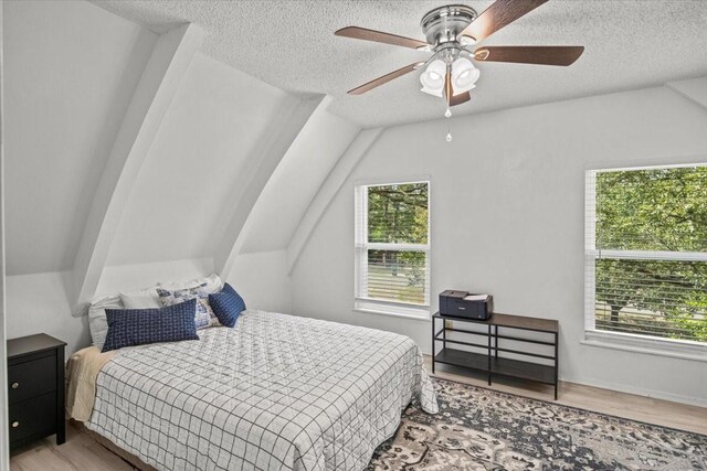315 Highlander Hts, Hideaway, TX 75771 - bedroom with lofted ceiling, a ceiling fan, wood finished floors, and a textured ceiling