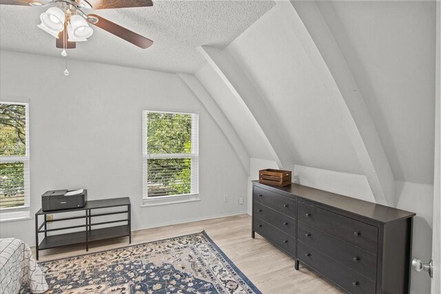 315 Highlander Hts, Hideaway, TX 75771 - bedroom featuring light wood-type flooring, vaulted ceiling, and a textured ceiling