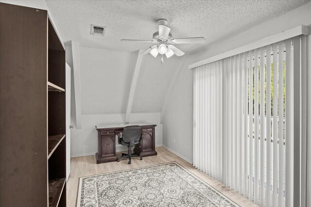 315 Highlander Hts, Hideaway, TX 75771 - home office featuring a textured ceiling, light wood-type flooring, ceiling fan, lofted ceiling, and visible vents