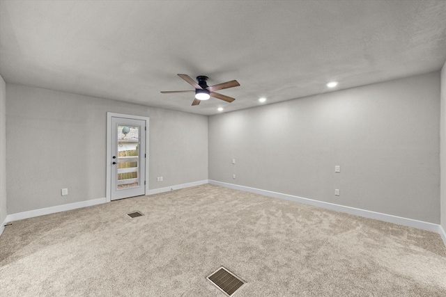 carpeted empty room featuring recessed lighting, a ceiling fan, visible vents, and baseboards