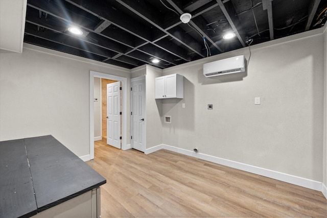 finished basement with light wood finished floors, an AC wall unit, and baseboards