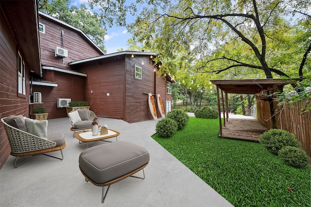 view of yard with a wall mounted air conditioner and a patio area