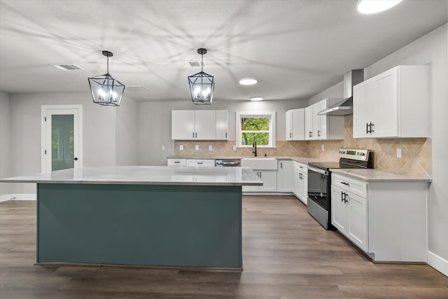 kitchen featuring stainless steel appliances, white cabinets, hanging light fixtures, and a kitchen island