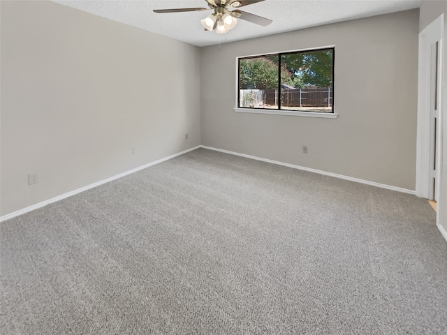 unfurnished room with ceiling fan, carpet flooring, and a textured ceiling