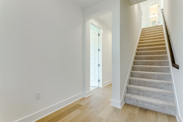 stairway featuring wood-type flooring