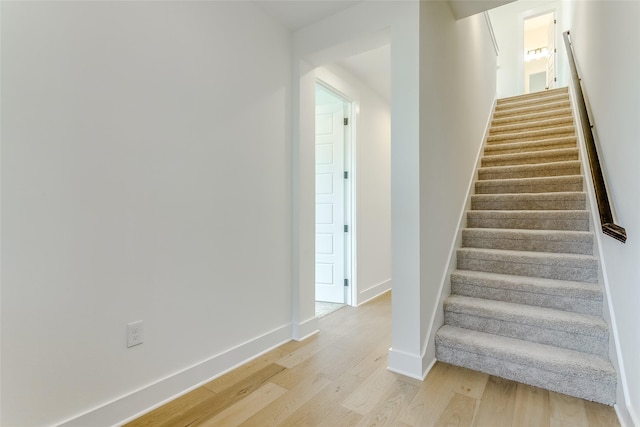 stairs featuring hardwood / wood-style flooring