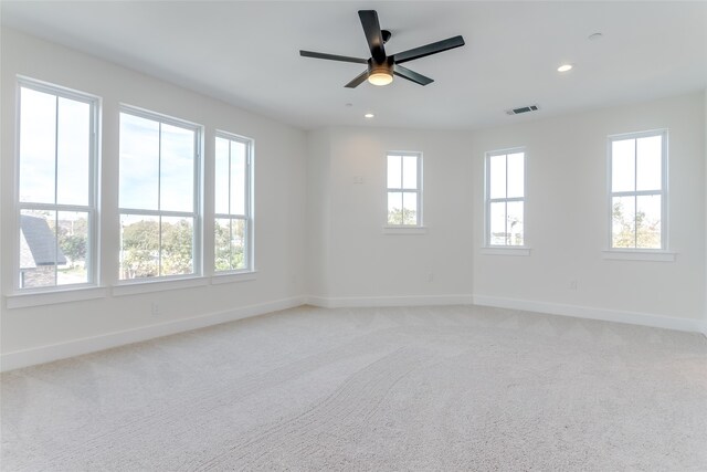 unfurnished room featuring visible vents, baseboards, light colored carpet, ceiling fan, and recessed lighting