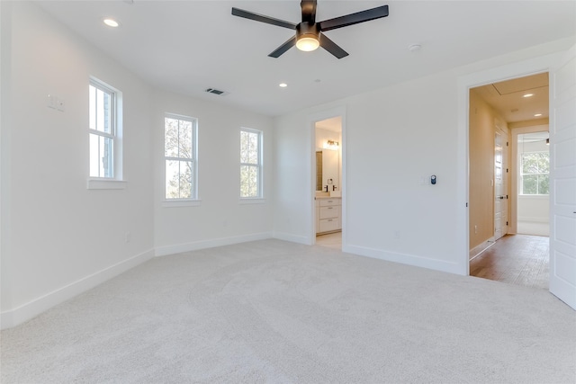 interior space with baseboards, ceiling fan, recessed lighting, and light colored carpet