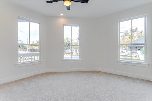 unfurnished room with plenty of natural light, carpet flooring, and baseboards