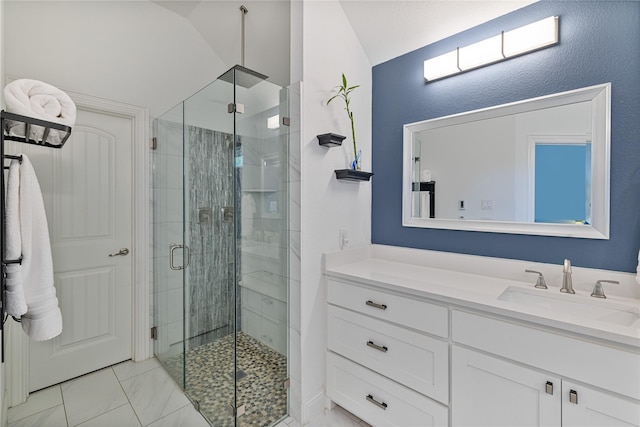 bathroom with vanity, lofted ceiling, and an enclosed shower