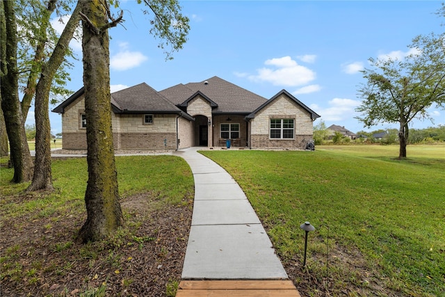 french country style house with a front lawn