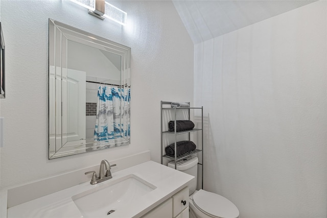 bathroom with vanity, curtained shower, vaulted ceiling, and toilet