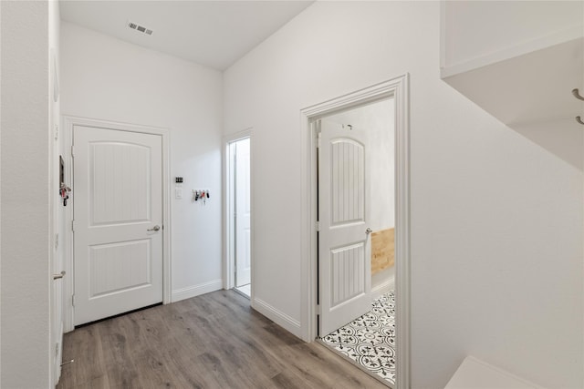 corridor with light hardwood / wood-style flooring