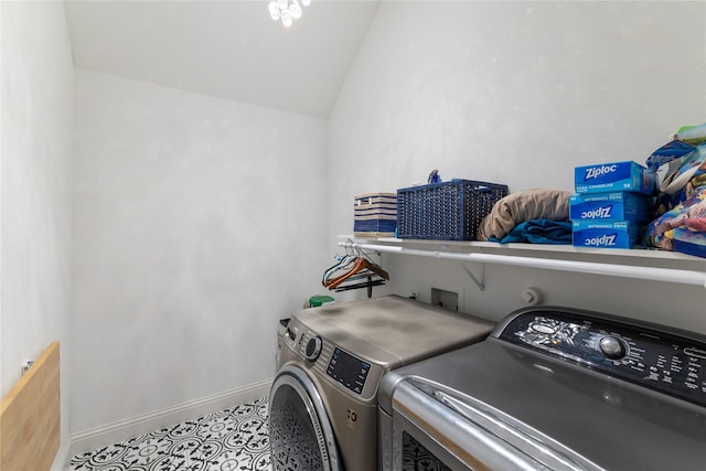 clothes washing area featuring light tile patterned flooring and washer and dryer