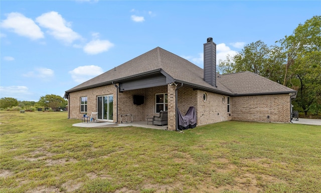 back of property featuring a patio area and a lawn