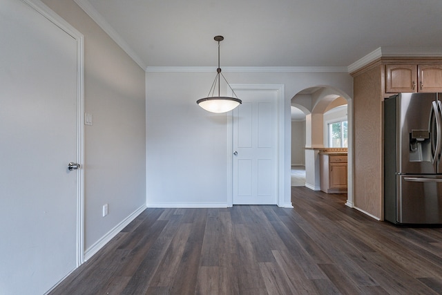 interior space with ornamental molding, hanging light fixtures, stainless steel fridge, and dark hardwood / wood-style flooring