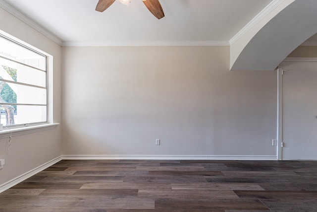 empty room with ornamental molding, ceiling fan, and dark hardwood / wood-style flooring