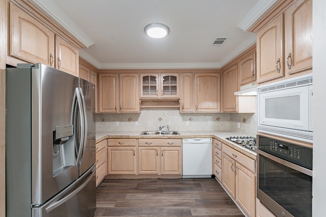 kitchen with sink, stainless steel appliances, light brown cabinetry, dark hardwood / wood-style flooring, and decorative backsplash