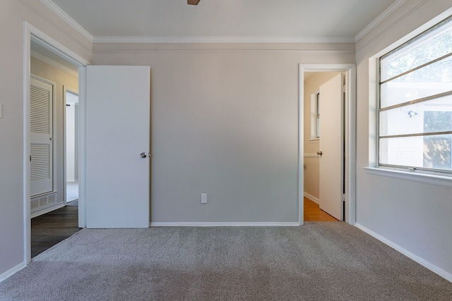 unfurnished bedroom featuring crown molding, carpet flooring, and ceiling fan