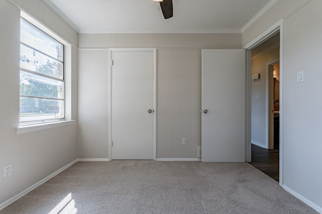 unfurnished bedroom with ceiling fan, carpet floors, and multiple windows