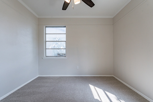 carpeted empty room with ceiling fan and crown molding