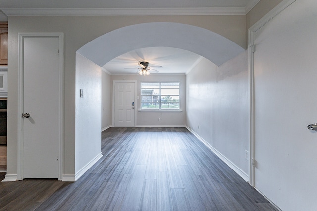 spare room featuring ornamental molding, dark hardwood / wood-style flooring, and ceiling fan