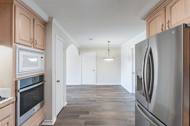 kitchen featuring decorative light fixtures, dark wood-type flooring, appliances with stainless steel finishes, light brown cabinetry, and crown molding