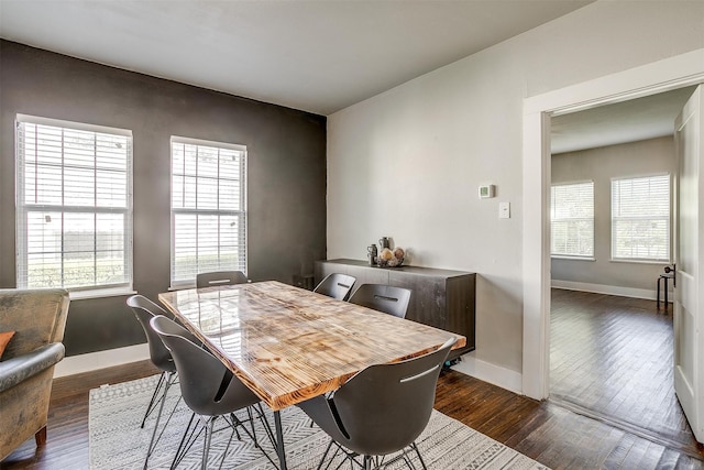 dining area with dark hardwood / wood-style flooring