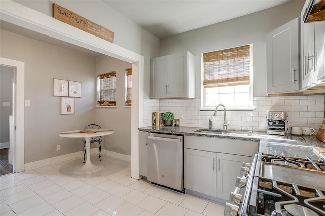 kitchen featuring sink, white cabinetry, decorative backsplash, stainless steel appliances, and stone countertops