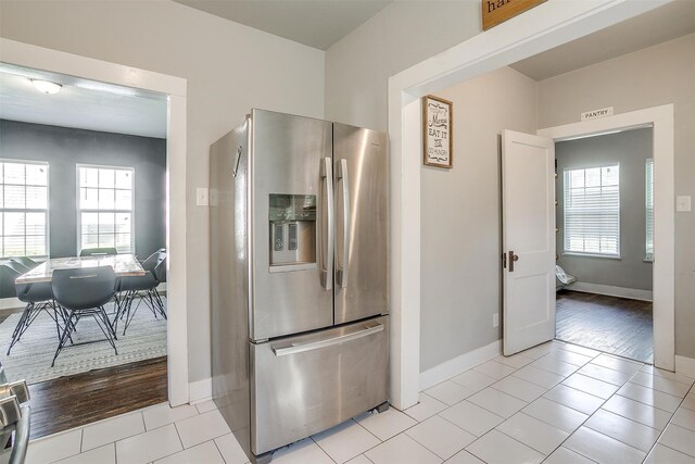 kitchen with light hardwood / wood-style floors and stainless steel fridge