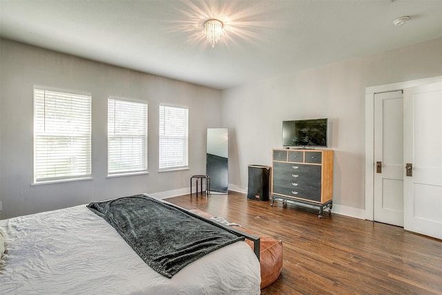 bedroom with dark hardwood / wood-style flooring