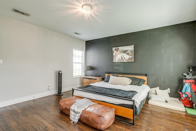 bedroom with dark wood-type flooring