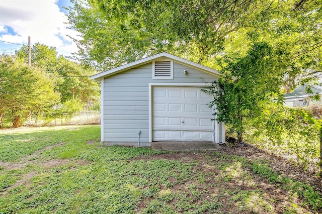 garage featuring wood walls and a yard