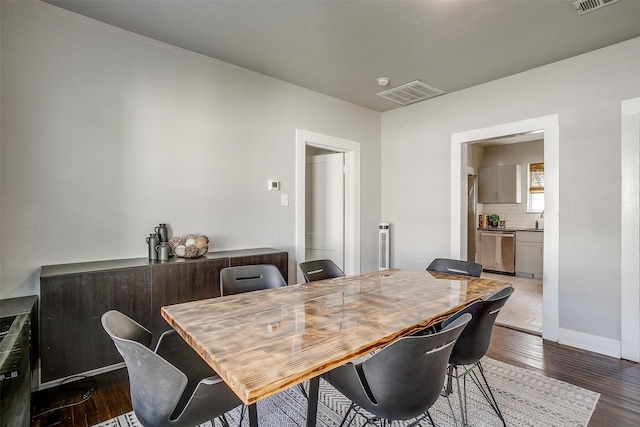 dining space featuring dark hardwood / wood-style flooring