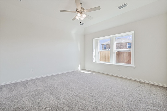 carpeted spare room featuring ceiling fan