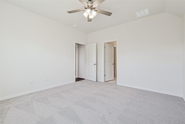 empty room featuring light carpet, lofted ceiling, and ceiling fan