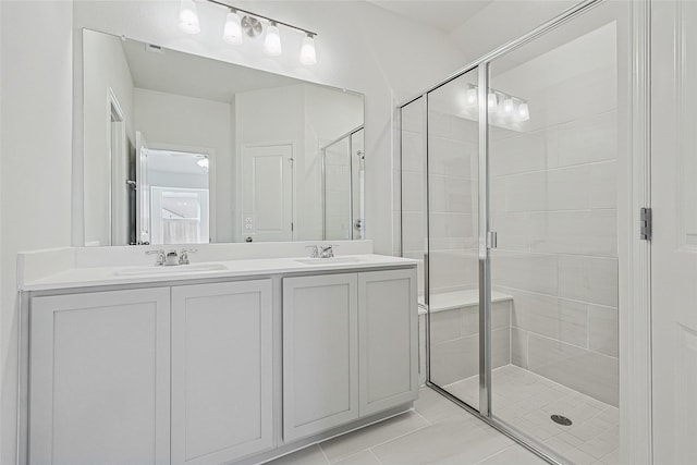 bathroom featuring tile patterned flooring, vanity, and an enclosed shower