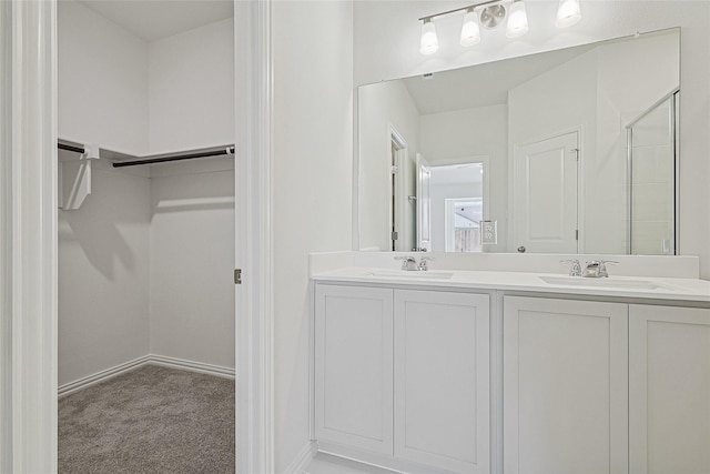 bathroom with vanity and a shower with door