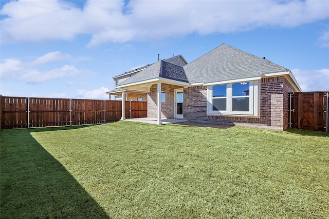 back of property featuring a patio and a yard