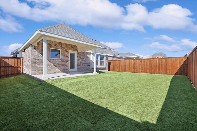 back of house featuring a patio area and a lawn