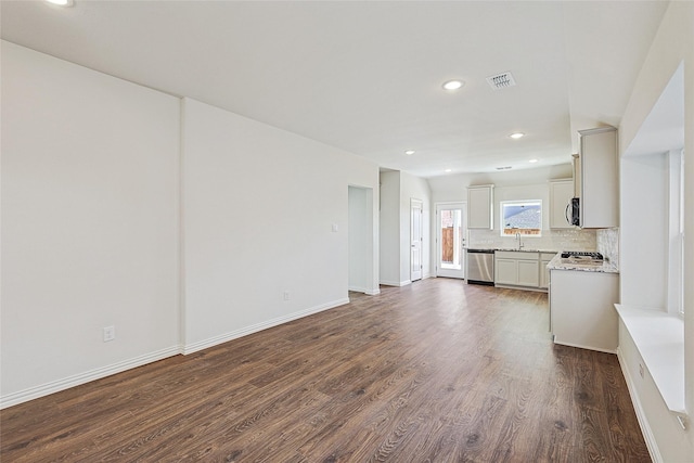 unfurnished living room featuring dark hardwood / wood-style flooring and sink