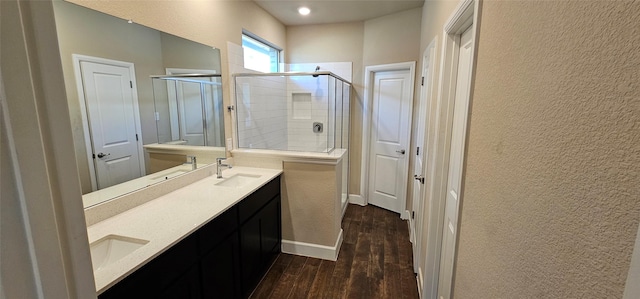 bathroom with wood-type flooring, vanity, and walk in shower