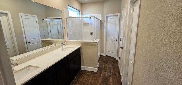 bathroom featuring hardwood / wood-style flooring, vanity, and an enclosed shower