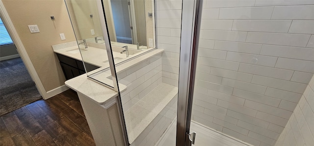 bathroom with walk in shower, wood-type flooring, and vanity