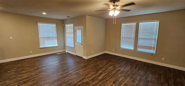 unfurnished room featuring ceiling fan and dark hardwood / wood-style floors