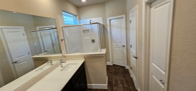 bathroom featuring a shower with door, vanity, and hardwood / wood-style floors